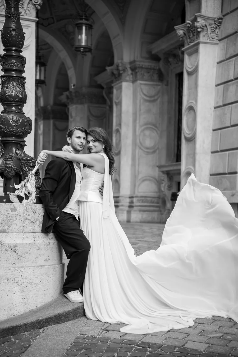 Fekete-fehér esküvői portré: pár egy klasszikus budapesti épület előtt, fátyollal — Gáspár Enikő Photography